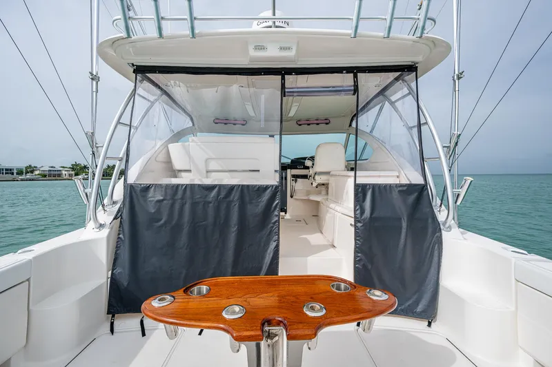 Slide: The Image of 2009 Tiara Yachts 39 Open boat interior with seating and wooden table, ocean view. - 35