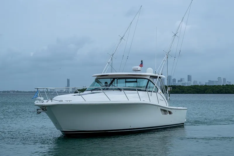 Slide: The Image of 2009 Tiara Yachts 39 Open cruising on calm waters with city skyline backdrop. - 4