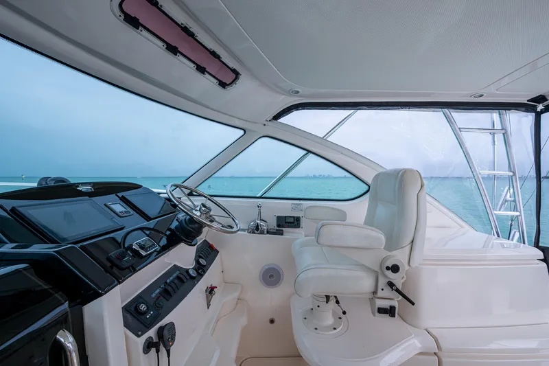 Slide: The Image of 2009 Tiara Yachts 39 Open helm with ocean view, featuring modern controls and seating. - 41