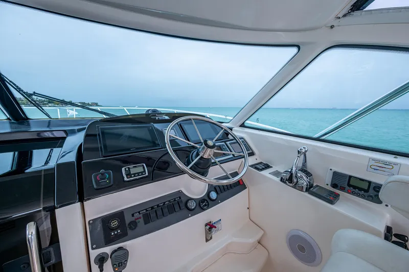 Slide: The Image of 2009 Tiara Yachts 39 Open helm with ocean view, showcasing steering wheel and controls. - 42