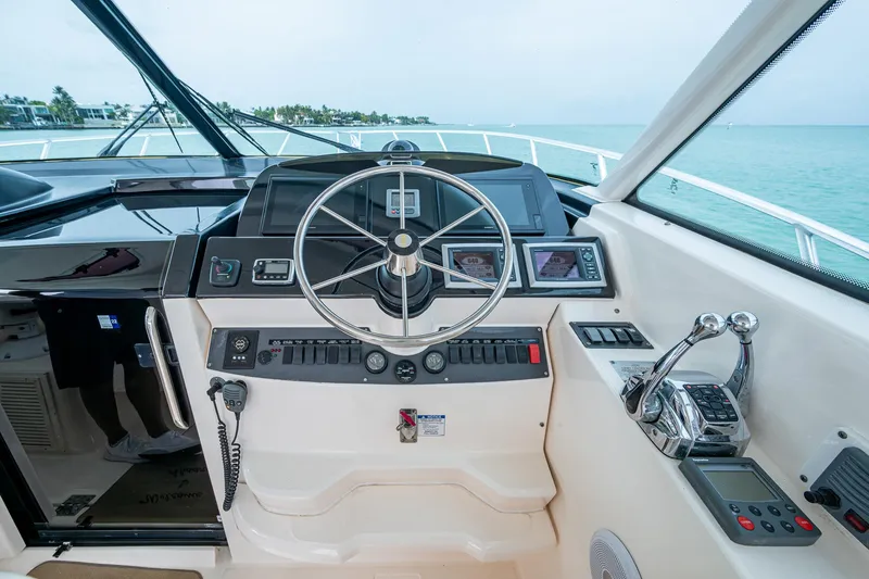 Slide: The Image of 2009 Tiara Yachts 39 Open helm with steering wheel and navigation controls. - 43