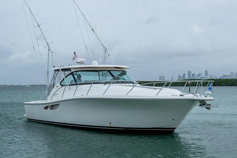 Slide: The Image of 2009 Tiara Yachts 39 Open boat on calm water with city skyline in background. - 6