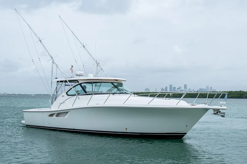 Slide: The Image of 2009 Tiara Yachts 39 Open boat on calm water with city skyline in background. - 7