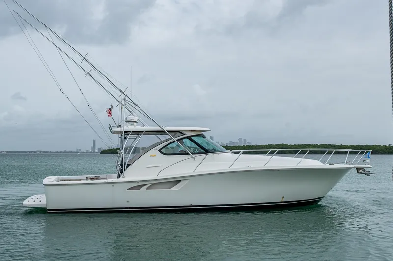 Slide: The Image of 2009 Tiara Yachts 39 Open cruising on calm waters under cloudy skies. - 8