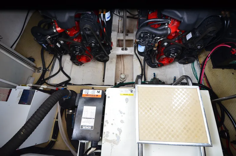 Slide: The Image of Engine compartment of a 2002 Larson 330 CABRIO boat, showcasing dual engines and mechanical components. - 18
