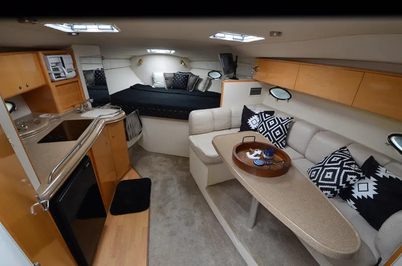 Slide: The Image of Interior of 2002 Larson 330 CABRIO yacht with cozy seating and modern amenities. - 3