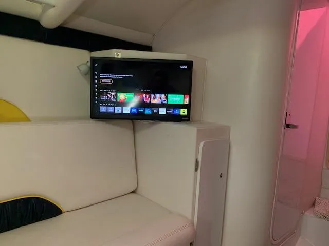 Slide: The Image of Interior of 2000 Donzi 38 ZX boat with wall-mounted TV and seating area. - 12