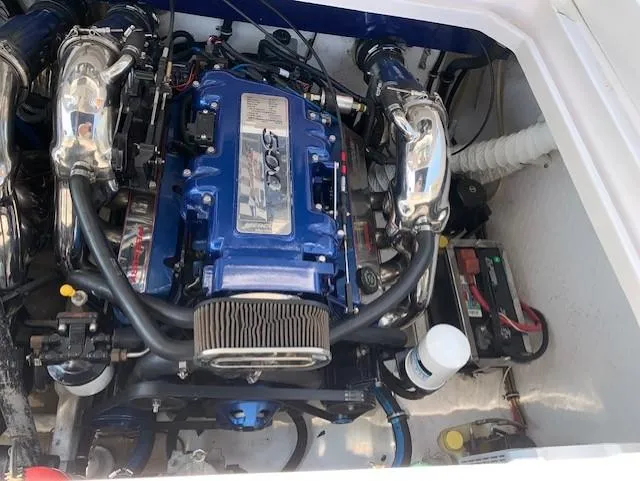 Slide: The Image of Engine compartment of a 2000 Donzi 38 ZX boat, featuring a powerful blue engine. - 18