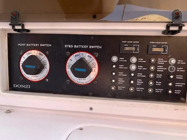 Slide: The Image of Control panel of a 2000 Donzi 38 ZX boat with battery switches and hour meters. - 21