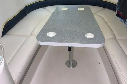 Slide: The Image of Interior of 2000 Donzi 38 ZX boat with cushioned seating and table. - 23