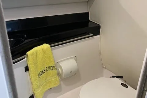 Slide: The Image of Bathroom interior of a 2000 Donzi 38 ZX boat with a yellow towel. - 25