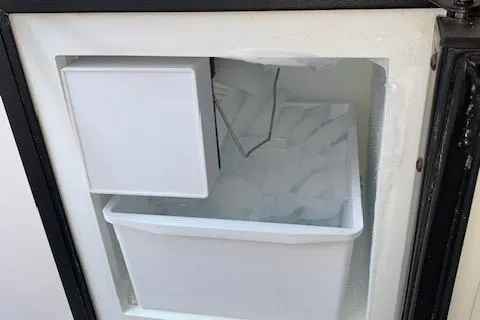 Slide: The Image of Ice maker inside a Donzi 38 ZX boat, model year 2000, with ice cubes visible. - 26