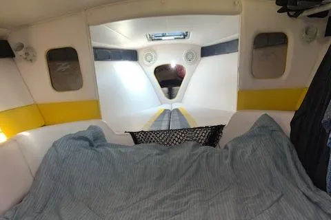 Slide: The Image of Interior cabin of a 2000 Donzi 38 ZX boat with bed and storage net. - 27