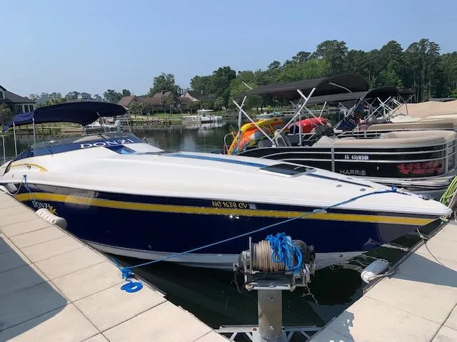 Slide: The Image of 2000 Donzi 38 ZX speedboat docked at a marina with other boats. - 3