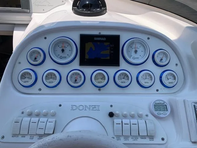 Slide: The Image of Dashboard of a 2000 Donzi 38 ZX boat with gauges and controls. - 8