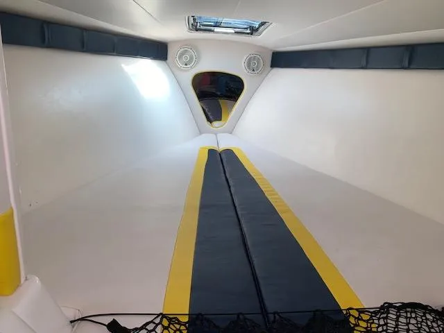 Slide: The Image of Interior of 2000 Donzi 38 ZX boat with yellow and blue accents. - 9