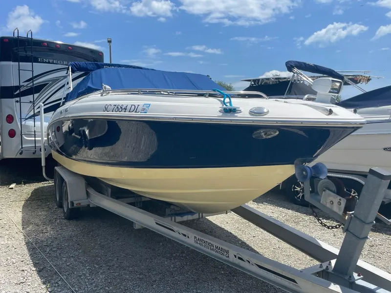 The Image of 2005 Chaparral 236SSi boat on trailer, parked outdoors under blue sky. - 0