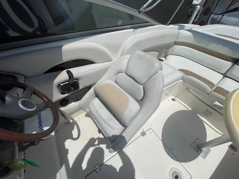 Slide: The Image of Interior of 2005 Chaparral 236SSi boat with white seating and steering wheel. - 10