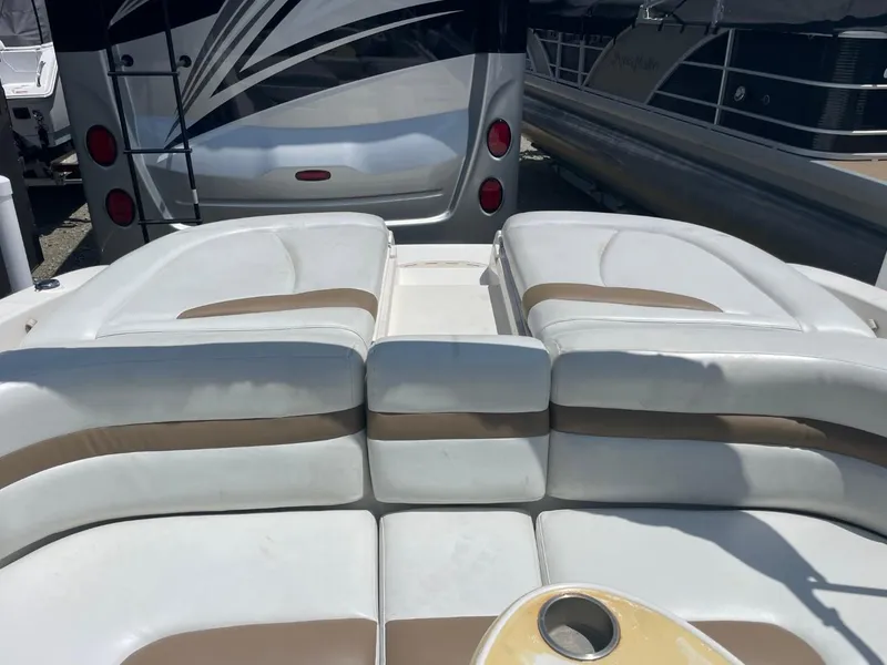 Slide: The Image of 2005 Chaparral 236SSi boat interior with white and beige seating. - 12