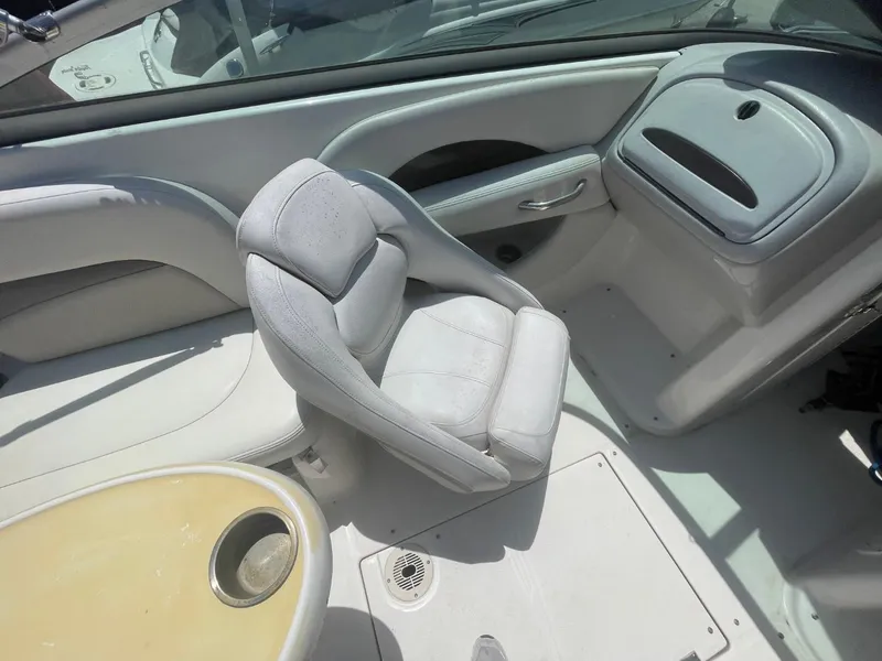 Slide: The Image of 2005 Chaparral 236SSi boat interior with white seating and dashboard. - 14