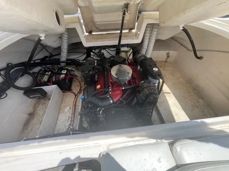Slide: The Image of Engine compartment of a 2005 Chaparral 236SSi boat, showcasing the engine and wiring. - 24