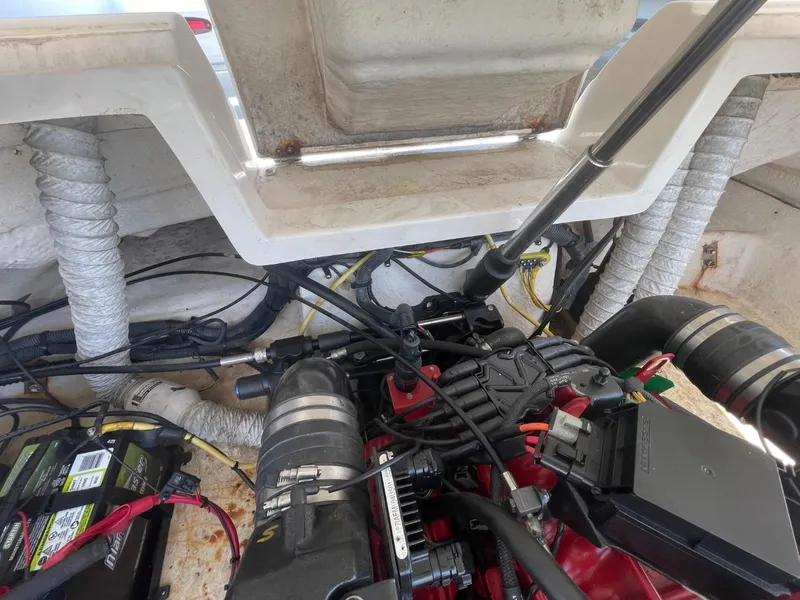 Slide: The Image of Engine compartment of a 2005 Chaparral 236SSi boat, showing mechanical components and wiring. - 25