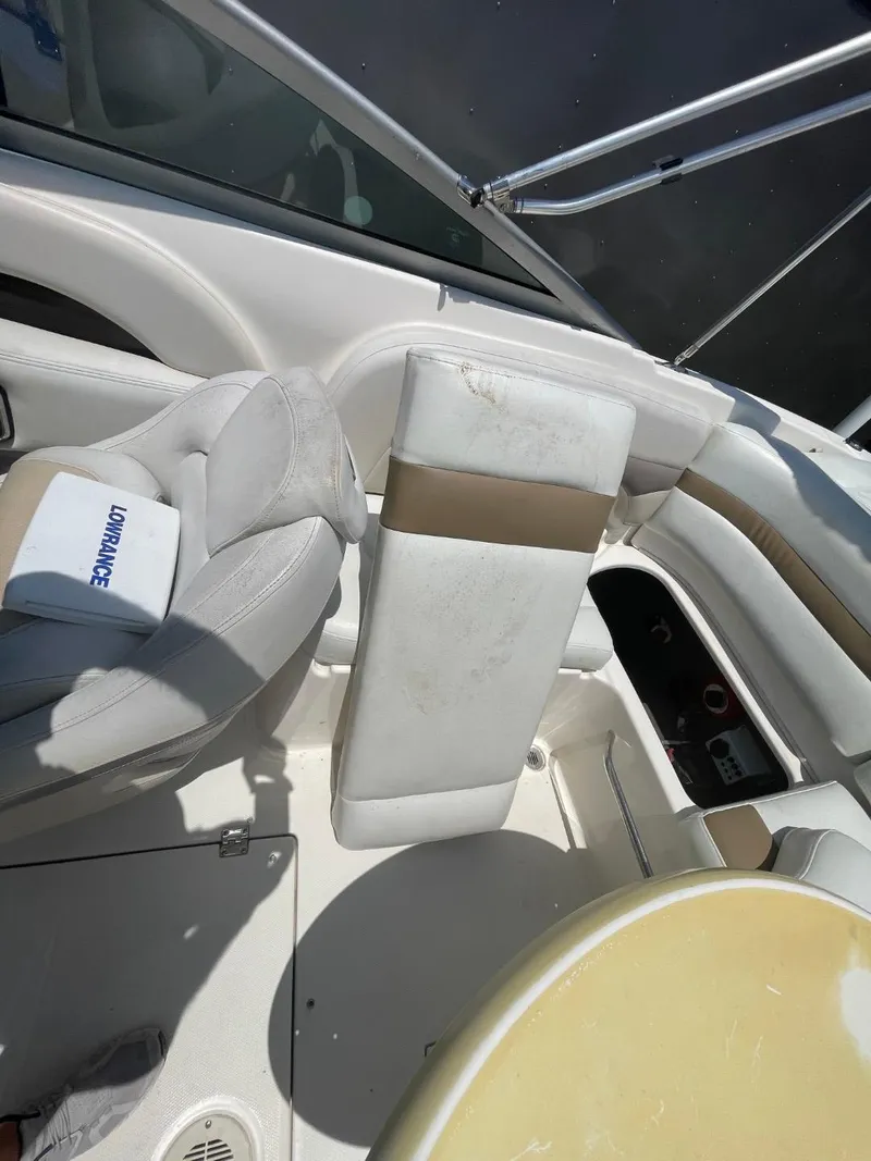Slide: The Image of 2005 Chaparral 236SSi boat interior with white and beige seating. - 26