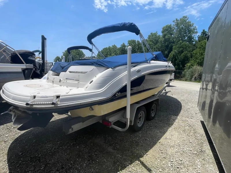 Slide: The Image of 2005 Chaparral 236SSi boat on trailer, blue canopy, parked outdoors. - 27