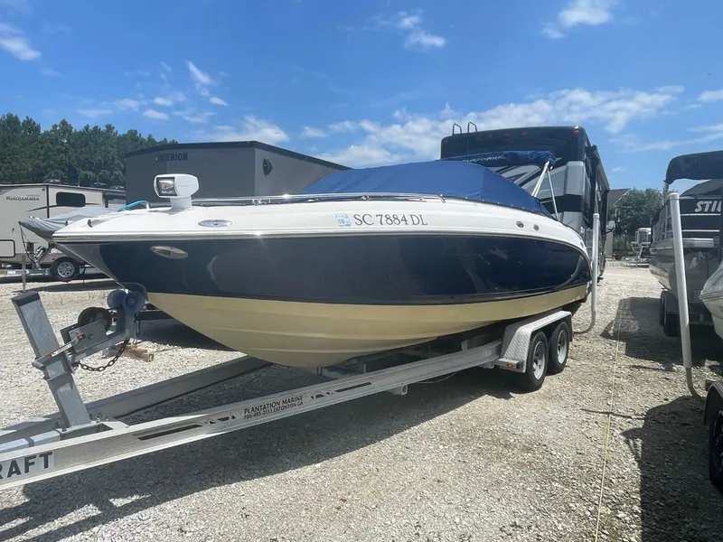 Slide: The Image of 2005 Chaparral 236SSi boat on trailer, parked outdoors under a clear blue sky. - 3