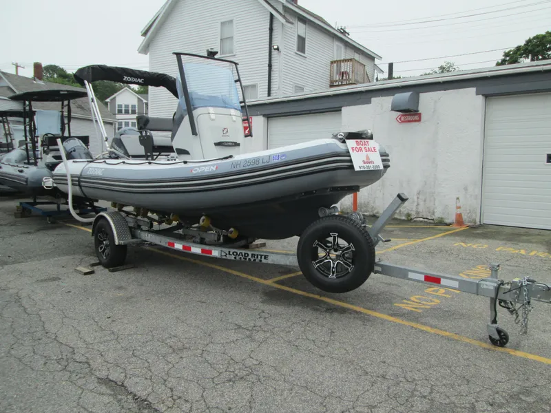 The Image of 2020 Zodiac Open 5.5 boat on trailer, parked outside, for sale sign visible. - 1