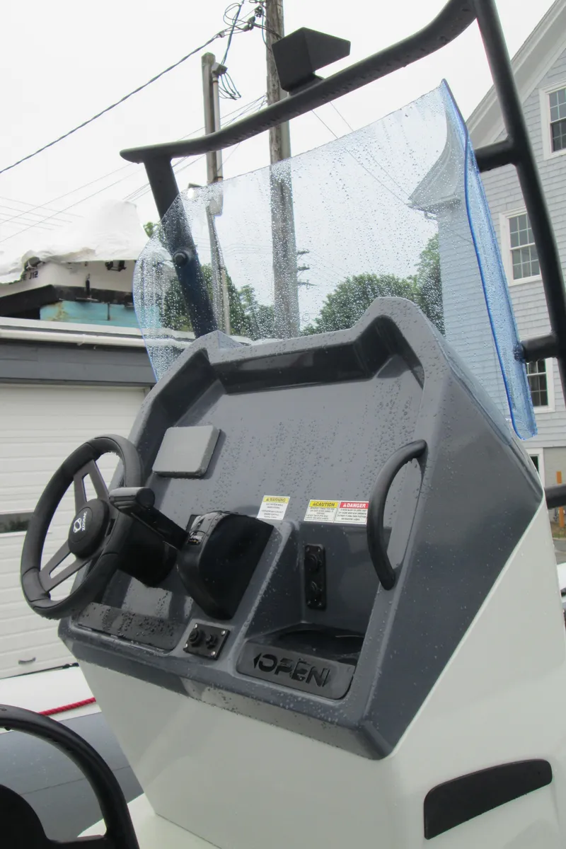 Slide: The Image of 2020 Zodiac Open 5.5 boat console with steering wheel and controls. - 6