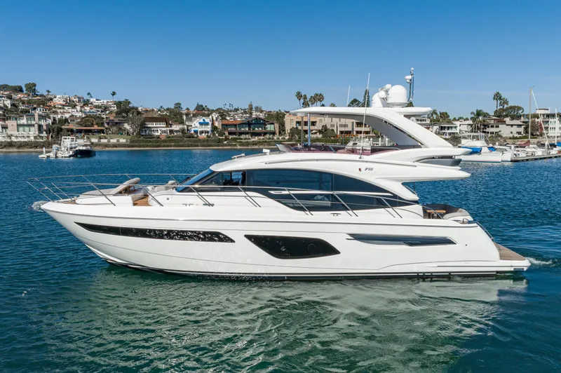 Slide: The Image of Luxury 2022 Princess F55 yacht cruising in a scenic harbor setting. - 19