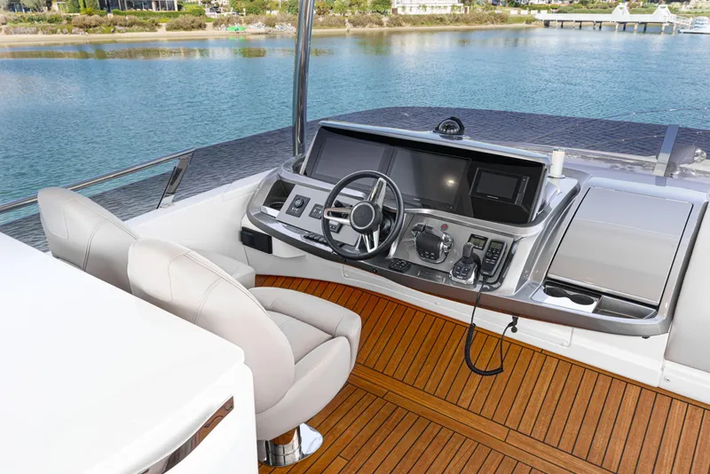 Slide: The Image of Luxurious helm of 2022 Princess F55 yacht with modern controls and scenic water view. - 30
