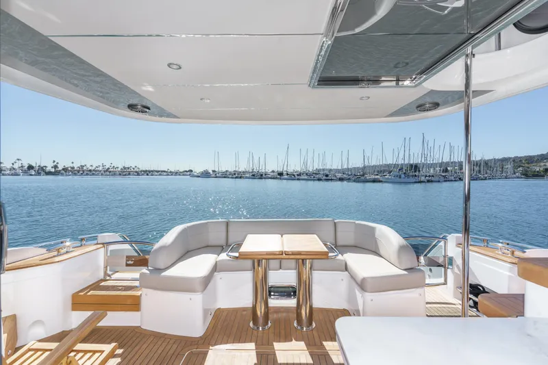 Slide: The Image of Luxurious 2022 Princess F55 yacht deck with seating, overlooking marina and calm waters. - 36