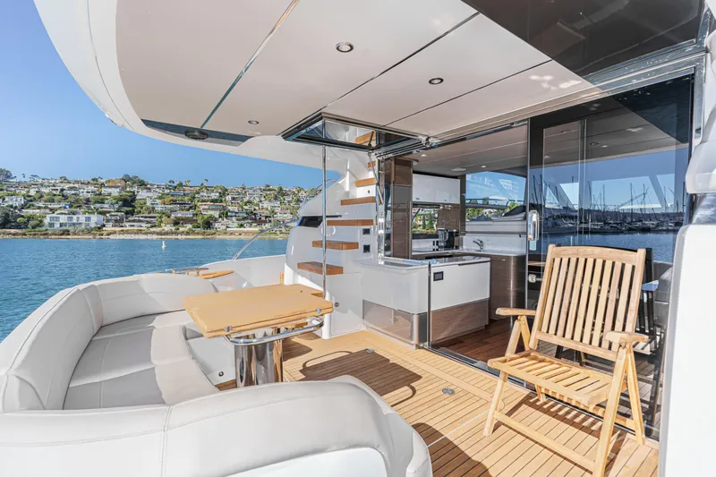Slide: The Image of Luxurious 2022 Princess F55 yacht deck with seating, table, and scenic waterfront view. - 38