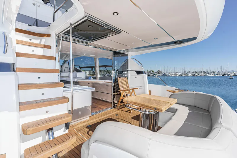 Slide: The Image of Luxurious 2022 Princess F55 yacht interior with elegant seating and wooden accents, docked at marina. - 40