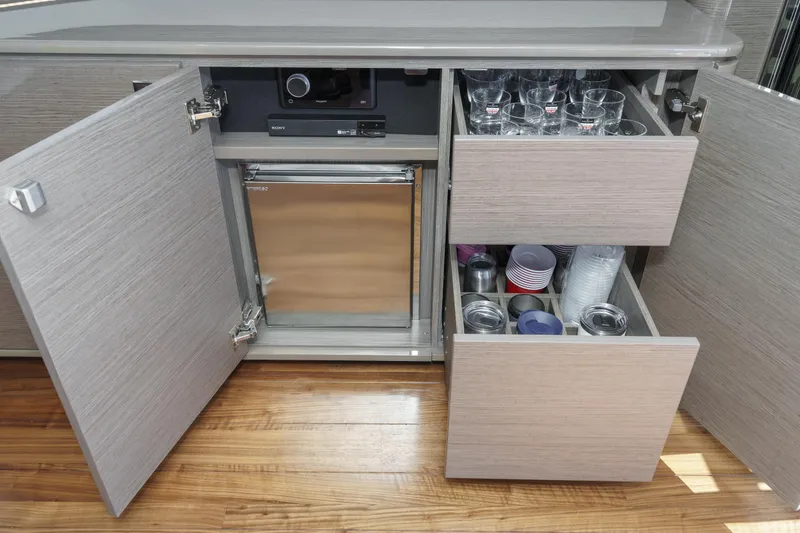 Slide: The Image of Modern yacht kitchen with open cabinets, drawers, and glassware storage on a Princess F55, 2022 model. - 44