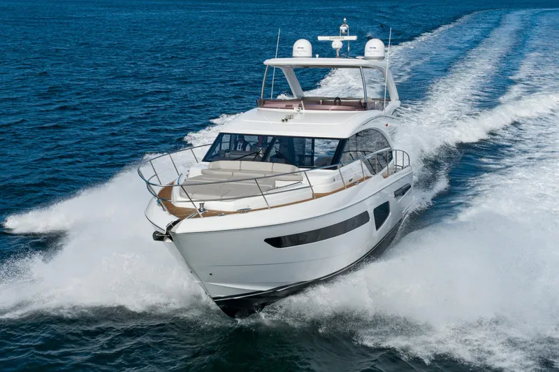 Slide: The Image of 2022 Princess F55 yacht cruising on open water, creating a dynamic wake. - 8