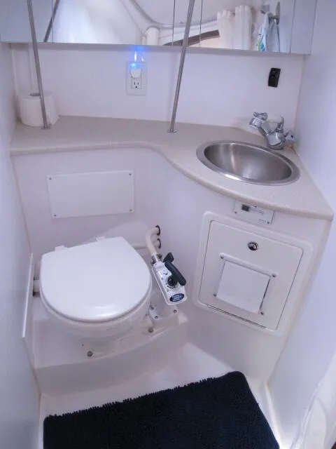 Slide: The Image of Compact bathroom in a 2015 Catalina 315 sailboat with toilet and sink. - 4