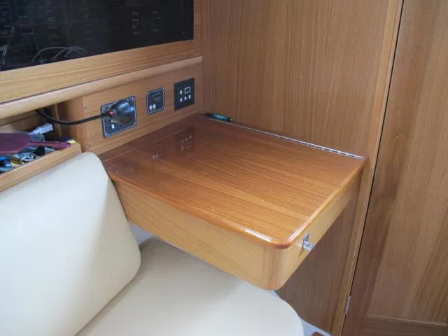 Slide: The Image of 2015 Catalina 315 interior with wooden table and control panel. - 5