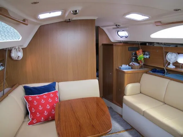 Slide: The Image of Interior of 2015 Catalina 315 sailboat with cozy seating and wooden table. - 7