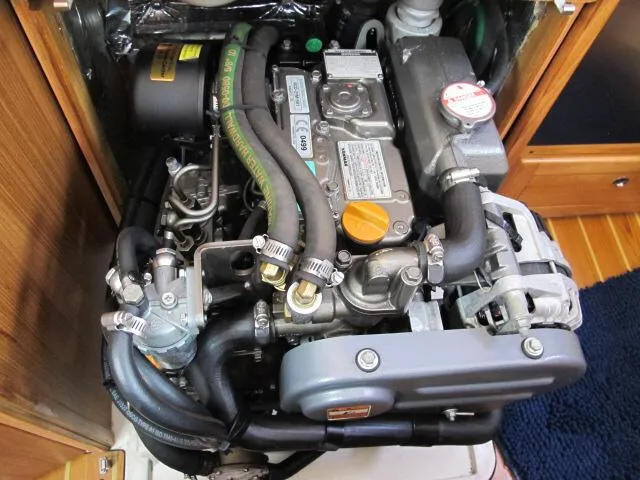 Slide: The Image of 2015 Catalina 315 engine compartment with visible components and hoses. - 9