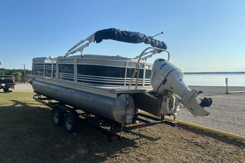 Slide: The Image of 2023 Nepallo 22TL Sport Toon pontoon boat on trailer by a lake. - 7
