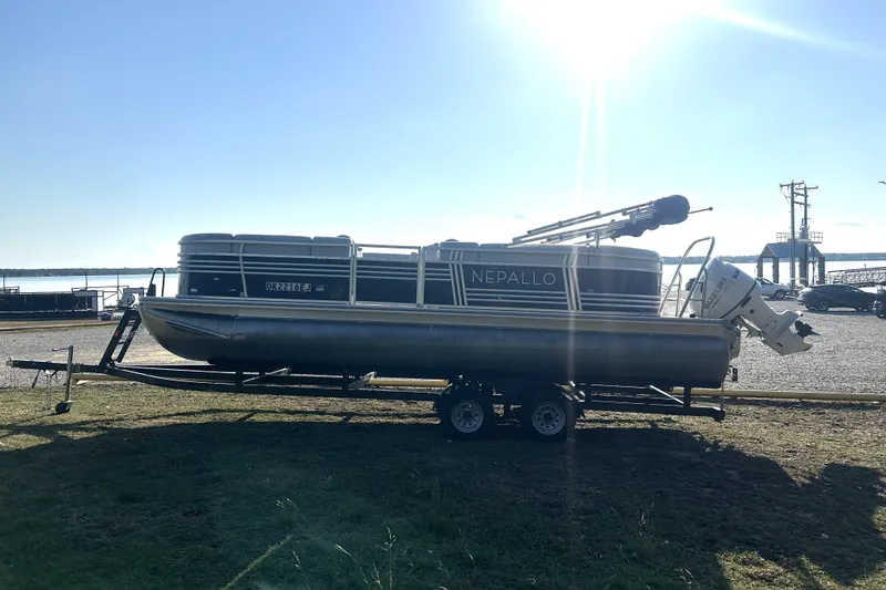Slide: The Image of 2023 Nepallo 22TL Sport Toon pontoon boat on trailer, parked near waterfront. - 8