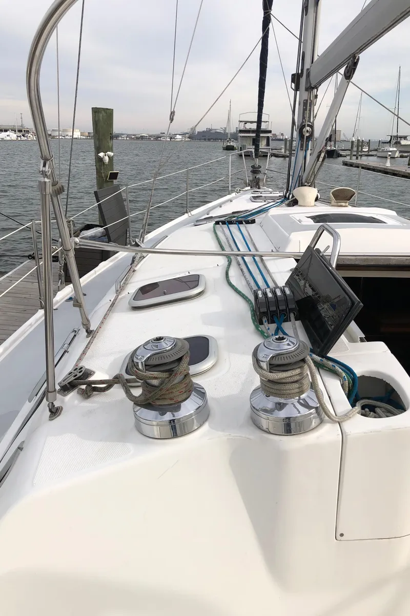 Slide: The Image of Sailboat deck view, Hunter 410 model, 2000, with winches and ropes in a marina setting. - 19