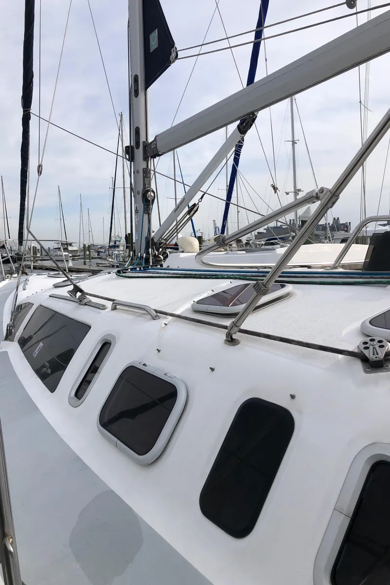 Slide: The Image of 2000 Hunter 410 sailboat docked, showcasing sleek design and rigging details. - 25