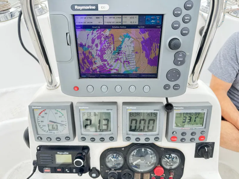 Slide: The Image of Boat navigation dashboard with Raymarine GPS, speedometer, and control panels on a 2000 Hunter 410. - 33