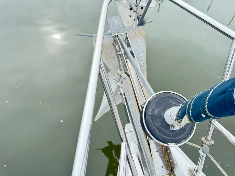 Slide: The Image of Bow of a 2000 Hunter 410 sailboat with anchor and railing over calm water. - 37