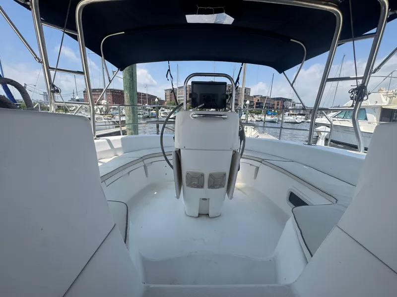 Slide: The Image of Cockpit view of 2000 Hunter 410 sailboat in marina, featuring steering wheel and seating. - 40