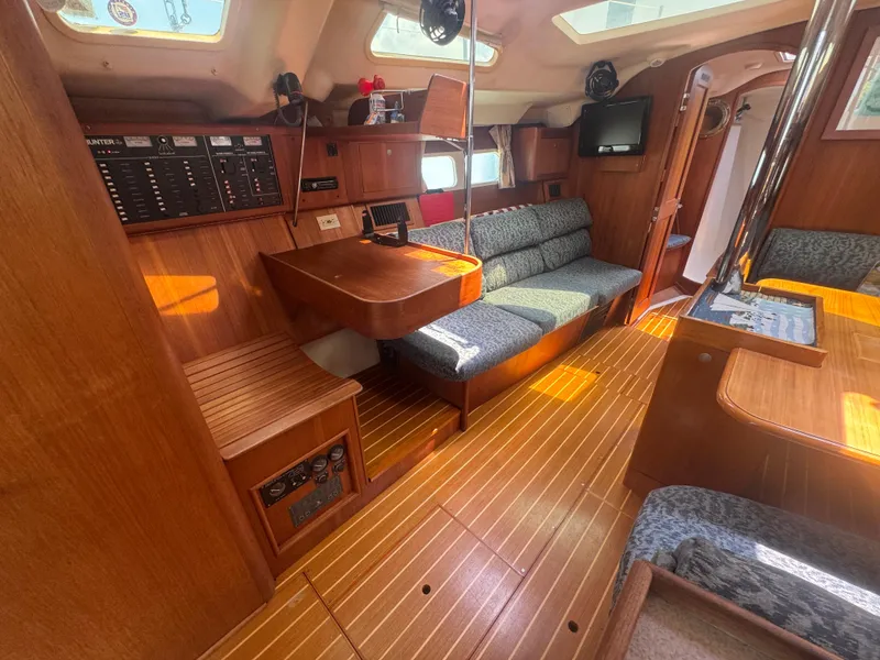 Slide: The Image of Interior of 2000 Hunter 410 sailboat with wood finish and seating area. - 43